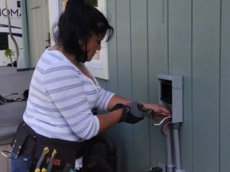 Licensed electrician wiring an exterior subpanel in Fayetteville